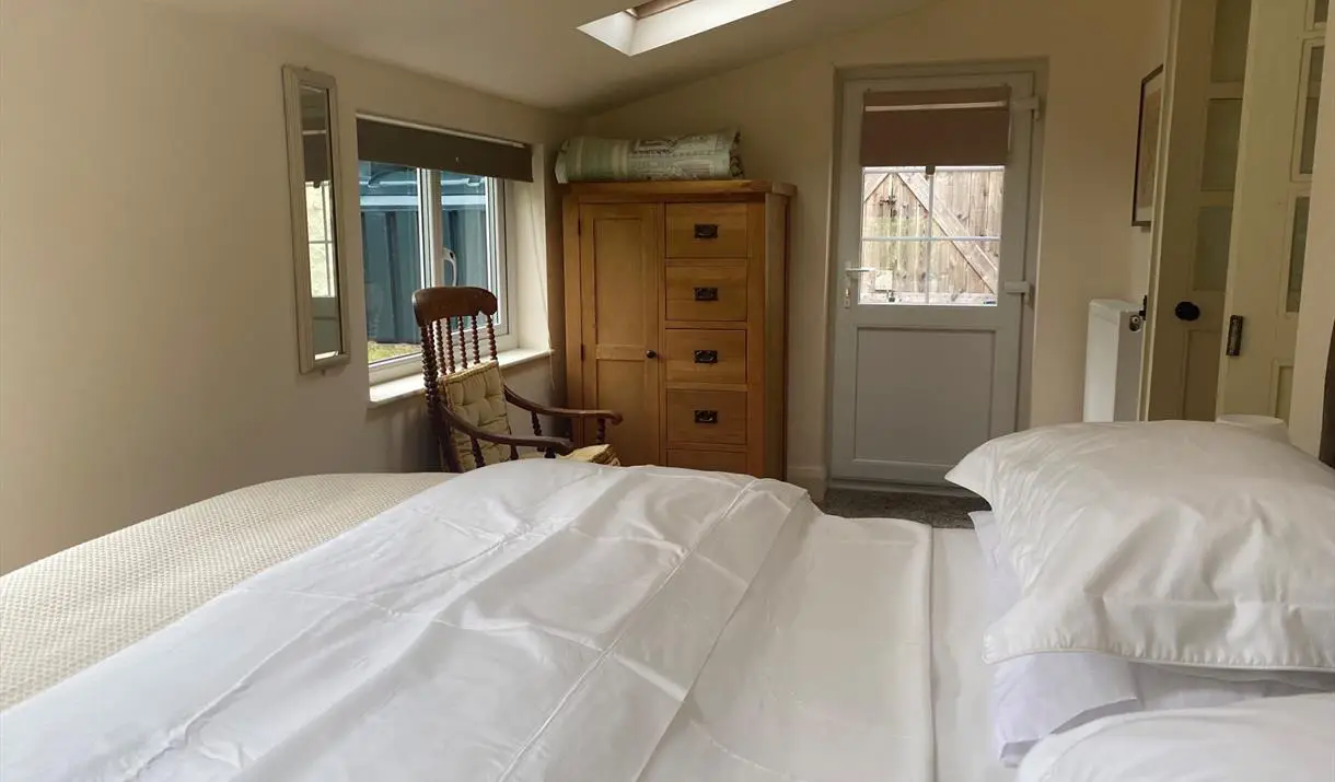 Comfortable twin bedroom with wooden wardrobe